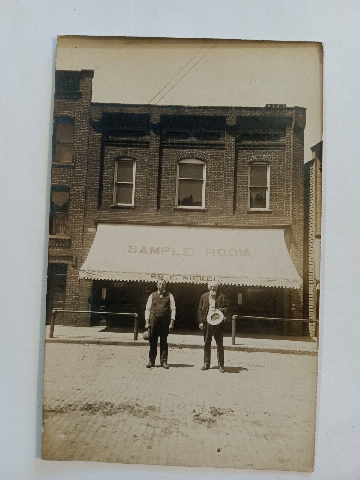SWANTON ? OHIO REAL PHOTO POSTCARD 1910 SAMPLE ROOM STORE BAR WM F NICKEL OWNERS